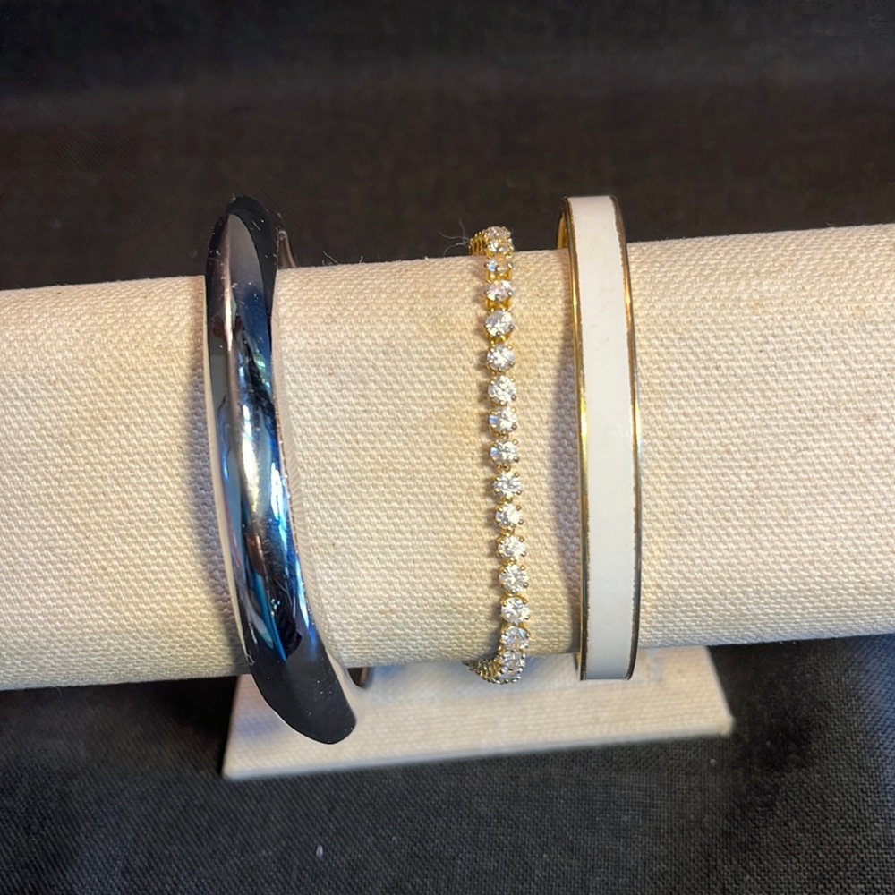 Three bracelets one rhinestone tennis, silver chrome bangle and white enamel